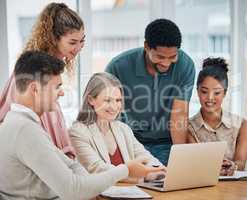 Teamwork, togetherness and unity with a team of colleagues and female leader, boss or manager working on a laptop during a boardroom meeting in the office. Planning, discussing and talking strategy