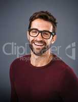 The perfect frames to enhance his handsomeness. Studio shot of a handsome and happy young man posing against a gray background.