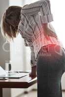 Poor posture can lead to great discomfort. a businesswoman suffering with back pain while working in an office.