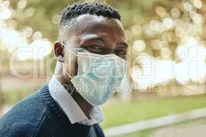 Face, mask and covid of a black businessman in the city for health and safety in the outdoors. Portrait of a happy man in a pandemic alone outside in nature with mockup background.