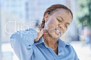 Woman manager with stress and pain in her neck while standing outside the office building. Female business leader at work with aching muscle in need of a wellness massage or a medical doctor for help