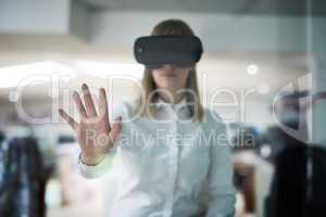Business has a brand new frontier. Multiple exposure shot of a young businesswoman wearing a VR headset while working alone in her office.