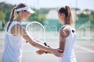 Tennis coach giving sports lesson to athlete for sporty, summer exercise, activity or hobby on outdoor court. Female instructor teaching and training woman for fitness, leisure or wellness lifestyle.