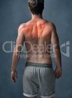 What hurts today makes you stronger tomorrow. Rearview shot of an unidentifiable young man with cgi indicating inflammation in his shoulders in studio.
