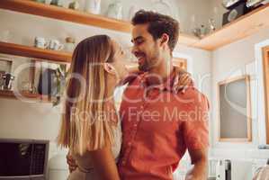 Romance, happy and love couple hugging, smile and bonding in kitchen. Romantic boyfriend and girlfriend embracing, enjoying their relationship and being carefree together.