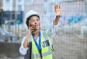 Construction worker, maintenance and development woman multitask on a phone while working. Building management employee on a work call helping holding up a hand on a contractor and builder job site