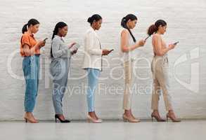 Technology, phone and creative women standing while browsing the internet or social media. Group of students with diversity doing research on internet. Multiracial females waiting for an interview.