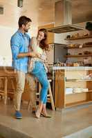 Love takes the lead. Full length shot of an affectionate young couple dancing in their kitchen.