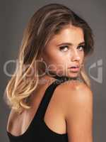 Be bold, be beautiful. Studio portrait of an attractive young woman posing against a dark background.