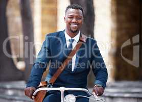 Portrait of a happy businessman on bike or bicycle on his morning travel into work in the city. Employee,, entrepreneur or worker on the ride with decrease his carbon footprint with a suite and smile