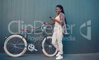 Girl, relax with bicycle and using smartphone app, social media and doing a internet or web search. Student uses her bike for health, fun workout or travel by cycling to school, university or college