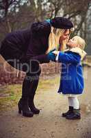 I will love you no matter how big you get. an adorable little girl and her mother outdoors.