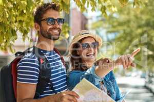 So many new things to see. a happy tourist couple using a map to explore a foreign city together.